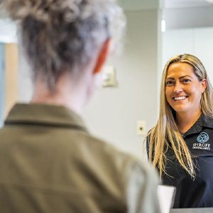 Woman at dental counter checking out