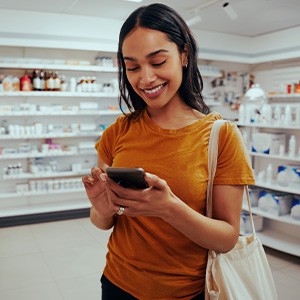 Patient looking at teeth whitening treatments at pharmacy