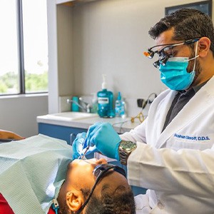 Woman in red shirt undergoing dental exam
