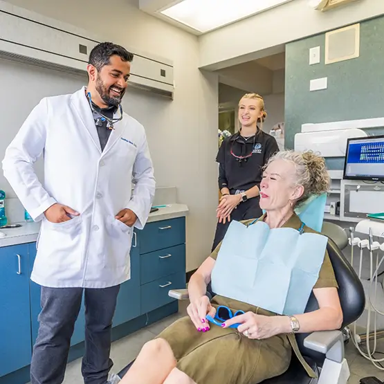 Dentist reviewing information with patient on clipboard