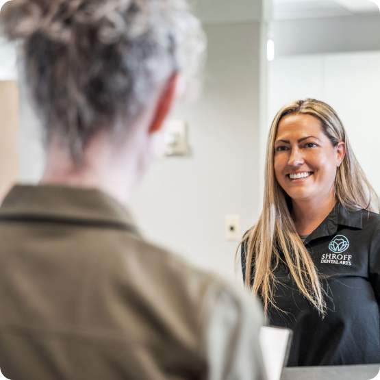 Female dental patient looking to side and smiling