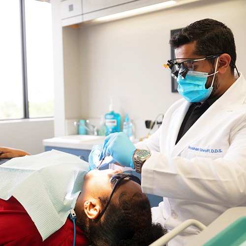 a dentist completing treatment on a patient