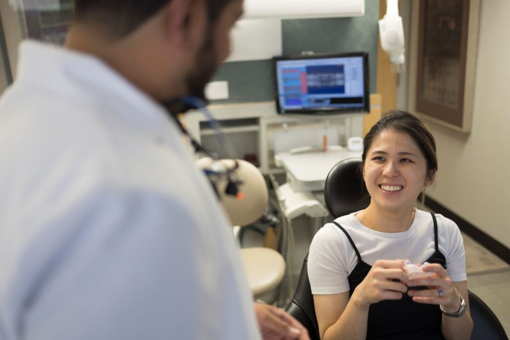 A patient discussing clear aligners with her dentist.