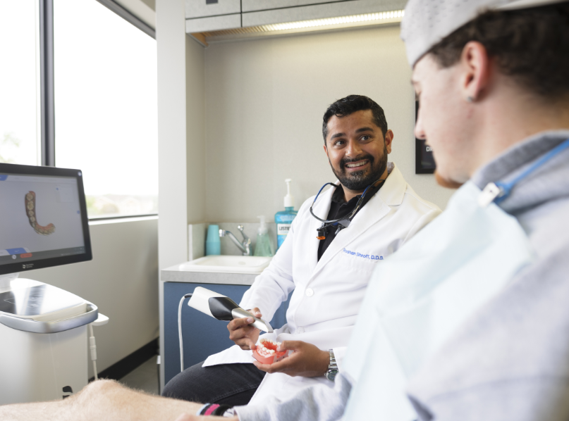 Dentist showing patient model teeth
